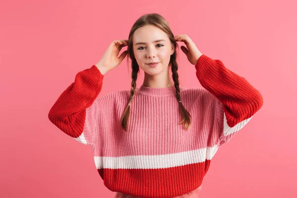 Young pretty smiling lady with two braids in sweater and skirt h — Stok fotoğraf