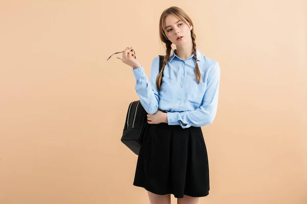 Young beautiful girl with two braids in blue shirt and skirt wit — 스톡 사진