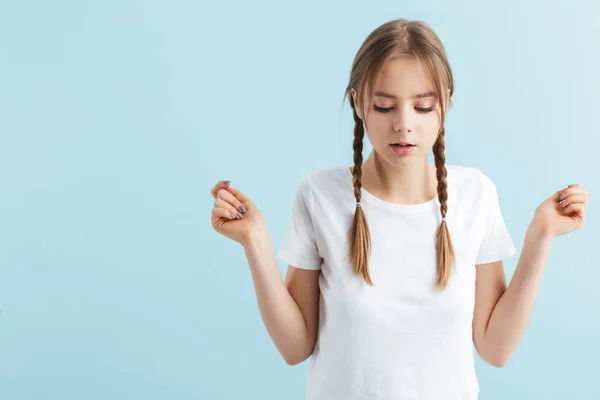 Young pensive girl with two braids in white t-shirt thoughtfully — 스톡 사진