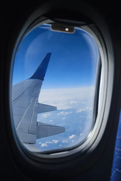 Vista de la ventana del avión en las nubes y el horizonte del cielo azul. Plano w — Foto de Stock