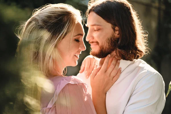 Portrait of young beautiful romantic couple happily hugging each other on date outdoor — Stock Photo, Image