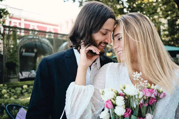 Portrait of beautiful romantic newlyweds happily hugging each other outdoor — Stock Photo, Image