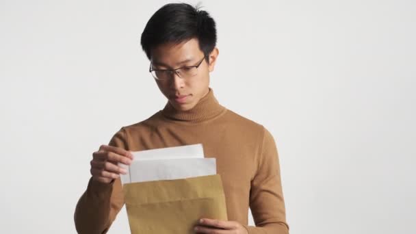 Young Attractive Asian Guy Opening Envelope Happily Looking Exams Results — Stock Video