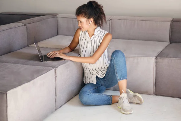 Bella sorridente casual ragazza asiatica felicemente lavorando sul computer portatile a casa moderna — Foto Stock