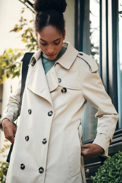 Attractive casual African American girl in stylish trench coat thoughtfully standing outdoor — 图库照片