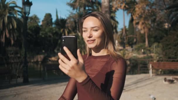 Şehir Parkında Yürürken Güzel Bir Kızın Görüntüsünü Izlemek Akıllı Telefondan — Stok video
