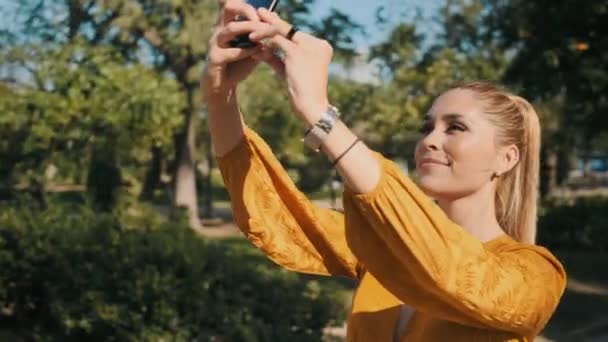 Sledování Záběr Mladé Nádherné Ženy Šťastně Fotografování Smartphone Během Procházky — Stock video