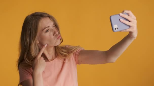 Beautiful Blond Girl Showing Different Expressions Taking Selfie Smartphone Colorful — Stock Video