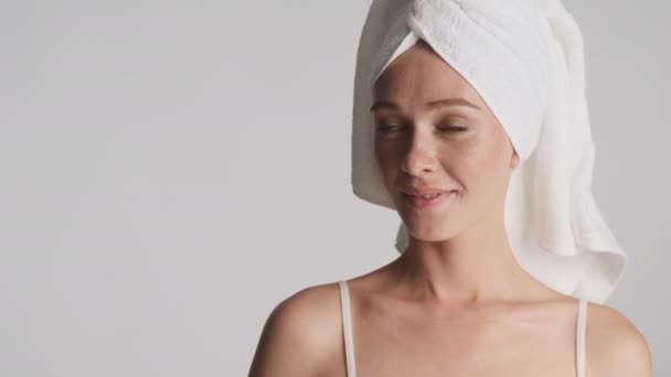아름다운 여인이 수건을 머리에 복제품 공간을 옆으로 바라보며 행복하게 얼굴을 — 비디오