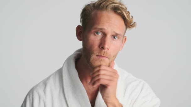 Attractive Blond Bearded Man Bathrobe Preening Camera White Background — Stok Video