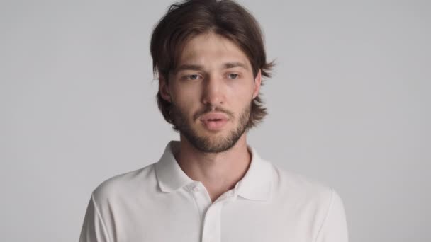 Portrait Young Weary Man Doubtfully Looking Posting Camera Gray Background — Stok Video