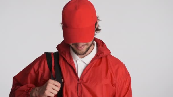 Handsome Delivery Guy Red Cap Jacket Backpack Confidently Looking Camera — Stock Video