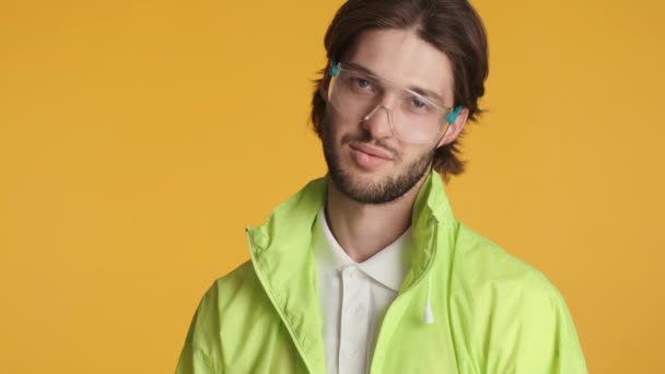 Koruyucu Gözlüklü Yakışıklı Esmer Adam Parlak Rüzgarlık Renkli Arka Planda — Stok video