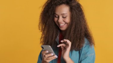 Çekici, sıradan esmer kız akıllı telefondan arkadaşlarıyla sohbet etmeyi sever. İyi internet bağlantısı