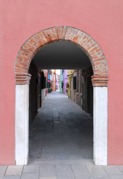 Street corridor entrance door with arch architecture on Burano island