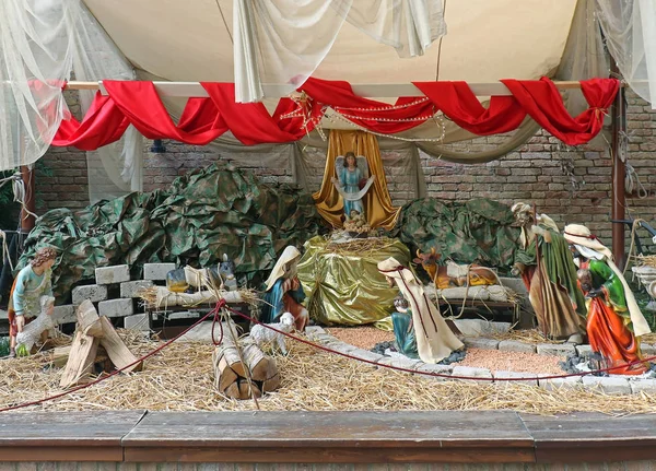 Birth of Jesus in native religious bible scene inside barn with decorative figurines