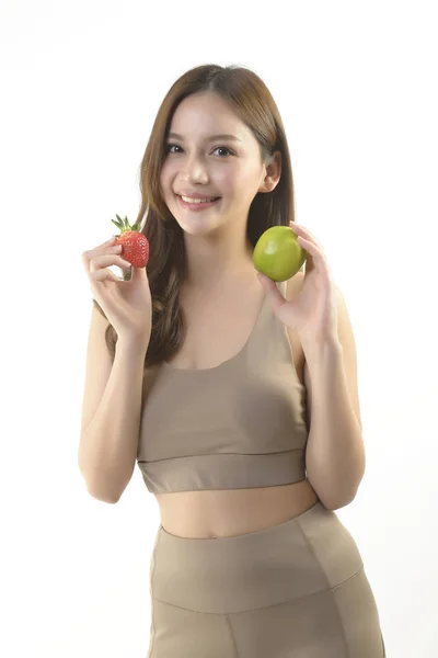 Jolie femme asiatique avec pomme et fraise sur fond blanc. — Photo