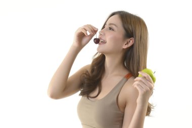 Beyaz arka plan üzerinde elma ve kiraz ile Pretty asya kadın.