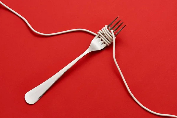 Fork wrapped with cable — Stock Photo, Image