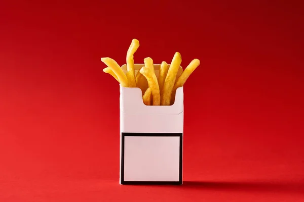 Fries inside cigarette pack — Stock Photo, Image