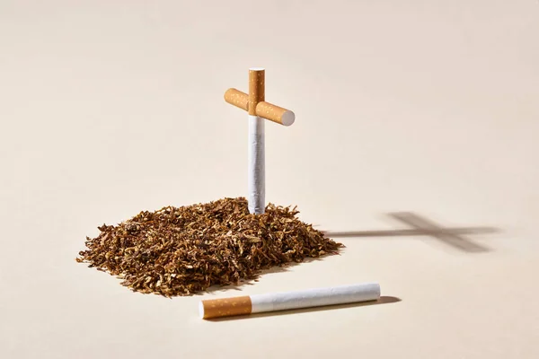 Tobacco grave with cigarette cross — Stock Photo, Image