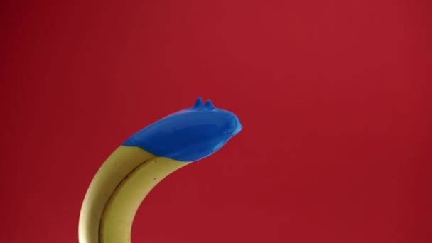 Banana with blue paint on it — Stock Video