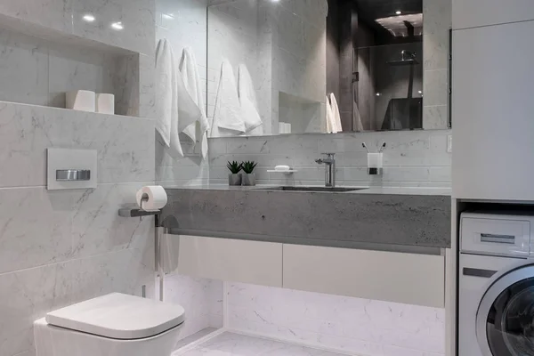 Illuminated modern bathroom with tiled walls and floor — Stock Photo, Image