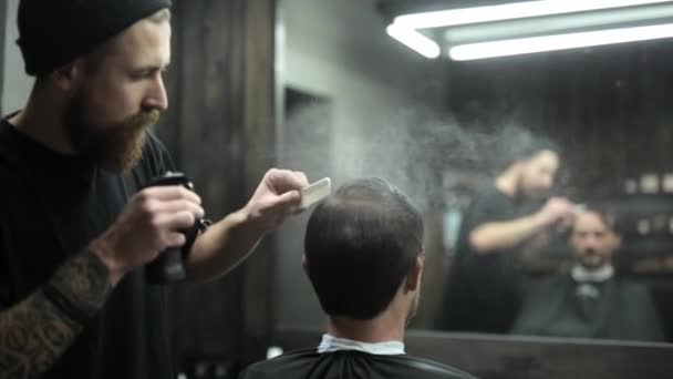 Стрижка темноволосого бородатого мужика в парикмахерской — стоковое видео