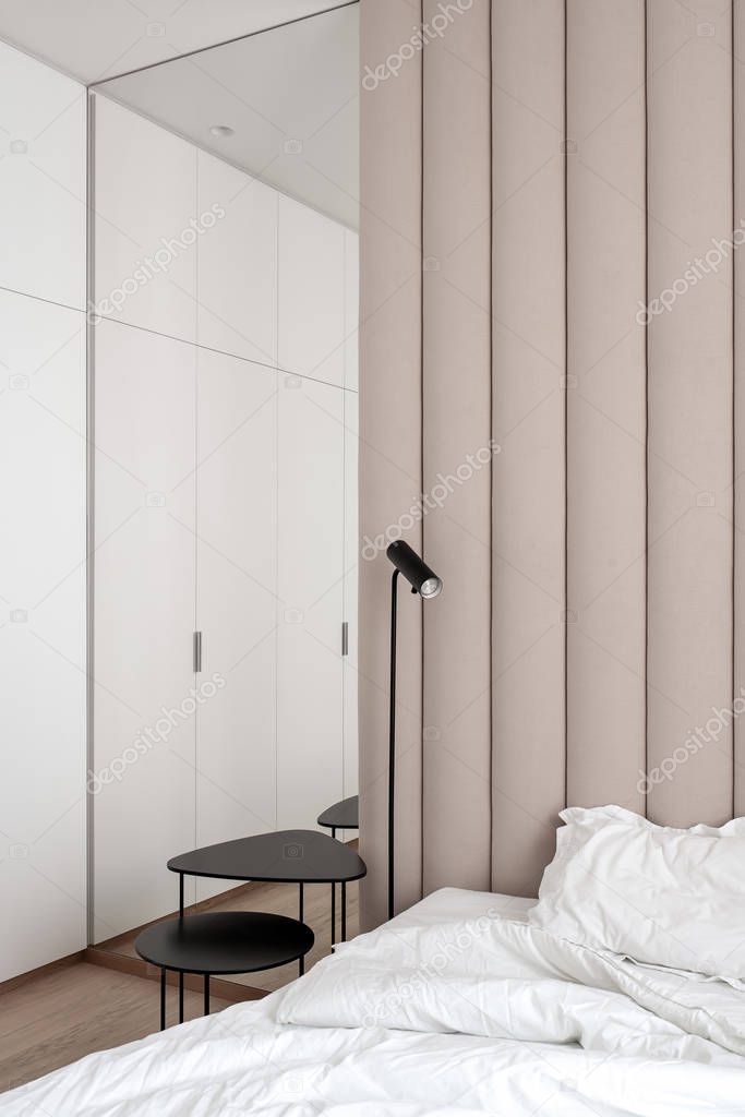 Stylish bedroom in modern style with brown textile wall panel