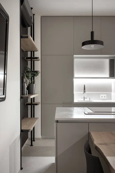 Kitchen in modern style with light walls and gray floor and illumination — Stock Photo, Image