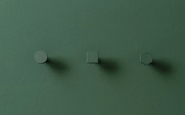 Metalowe wieszaki zielony w formach circle i square i sześciokąt na kolorowe ściany w studio — Zdjęcie stockowe
