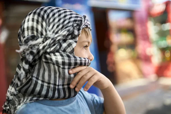 Small boy in checkered keffiyeh posing outdoors — Stock Photo, Image