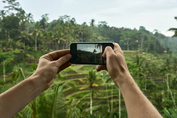 Mannen skytte foto på terrasserade ris fält bakgrund på Bali — Stockfoto