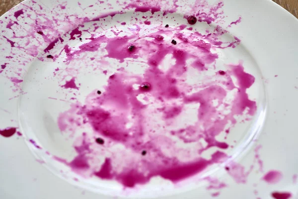 Splashes of juice of red pitahaya on white plate — Stock Photo, Image