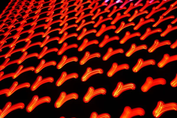 Foto de exposição longa de padrões de luz de néon colorido em movimento — Fotografia de Stock