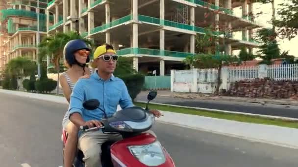 Parents with their little kid riding motorcycle on sunny city street — Stock Video