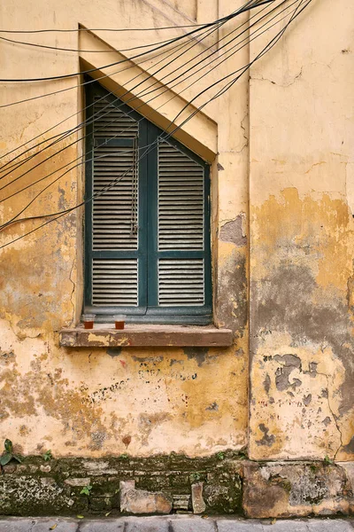 Exterior of vintage vietnamese house with shabby wall