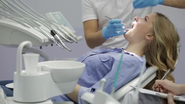 Hezké ženské zuby zkoumáním na zubní klinice — Stock video