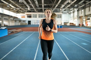 Kapalı stadyumda atletik sarışın kadın eğitim