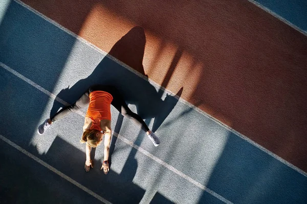 Mujer rubia deportiva entrenando en el estadio interior — Foto de Stock