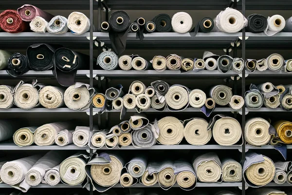 Fabric warehouse with many multicolored textile rolls — Stock Photo, Image