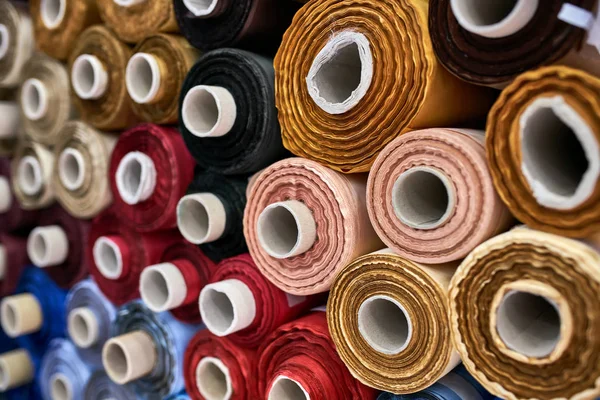 Fabric warehouse with many multicolored textile rolls — Stock Photo, Image
