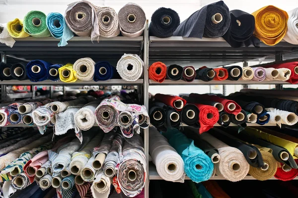 Fabric warehouse with many multicolored textile rolls — Stock Photo, Image