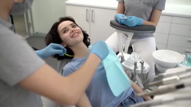 Ładna kobieta odwiedza swojego dentystę w klinice dentystycznej — Wideo stockowe
