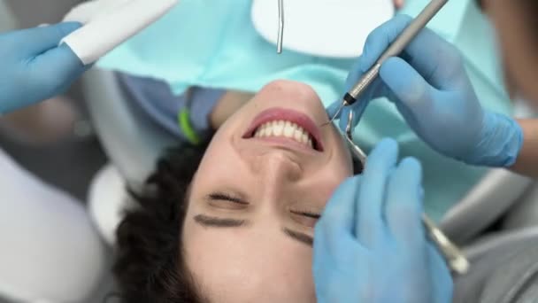 Pretty womans teeth treatment in dental clinic — Stock Video