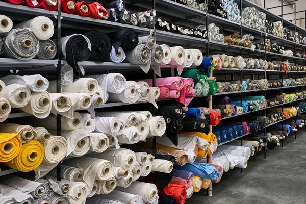Fabric warehouse with many multicolored textile rolls — Stock Photo, Image