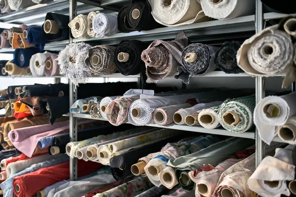 Fabric warehouse with many multicolored textile rolls — Stock Photo, Image