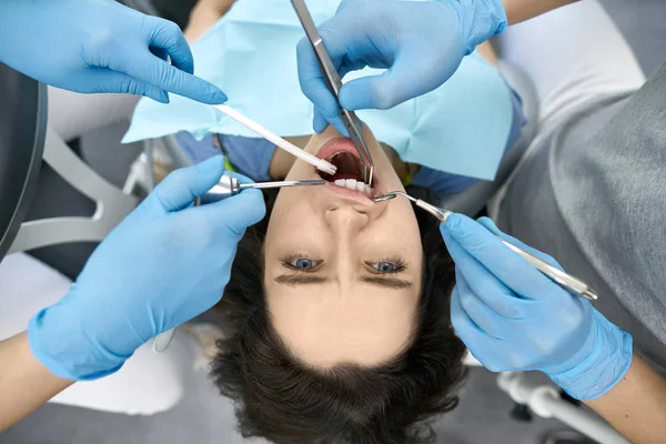 Pretty womans teeth treatment in dental clinic
