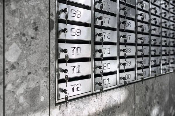 Numbered metal mailboxes with keys in them — Stock Photo, Image