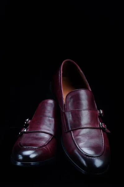 Leather, stylish menswear shoes on a black background with reflection